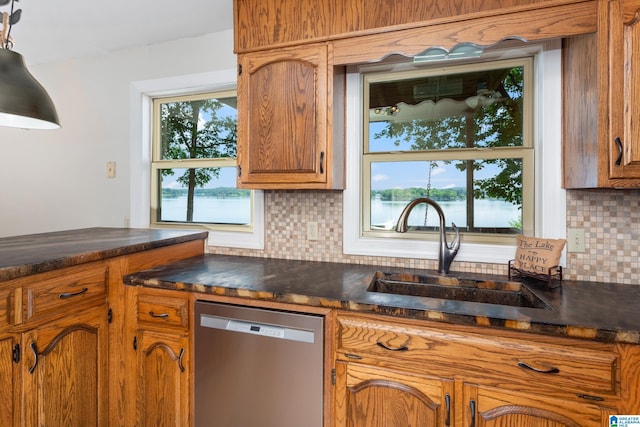 3516 Griffitt Bend Rd, Talladega, AL 35160 - kitchen featuring dishwasher, a sink, dark countertops, brown cabinets, and backsplash