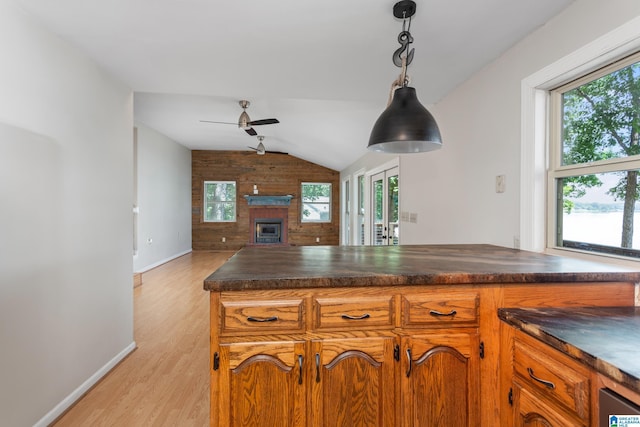 3516 Griffitt Bend Rd, Talladega, AL 35160 - kitchen with dark countertops, lofted ceiling, ceiling fan, open floor plan, and light wood-style flooring