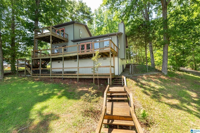 3516 Griffitt Bend Rd, Talladega, AL 35160 - back of house featuring stairs, a chimney, a yard, and a wooden deck