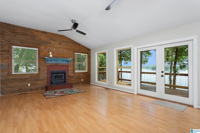 3516 Griffitt Bend Rd, Talladega, AL 35160 - unfurnished living room with a ceiling fan, lofted ceiling, wooden walls, french doors, and wood finished floors