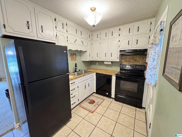 kitchen with under cabinet range hood, white cabinets, black appliances, a sink, and a textured ceiling