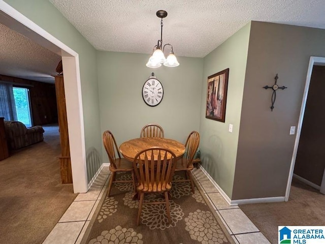 dining area featuring baseboards, an inviting chandelier, carpet floors, and a textured ceiling