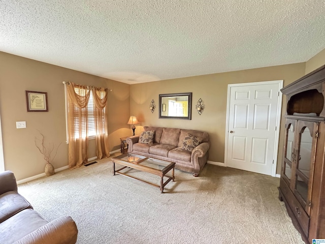 carpeted living area with a textured ceiling, visible vents, and baseboards