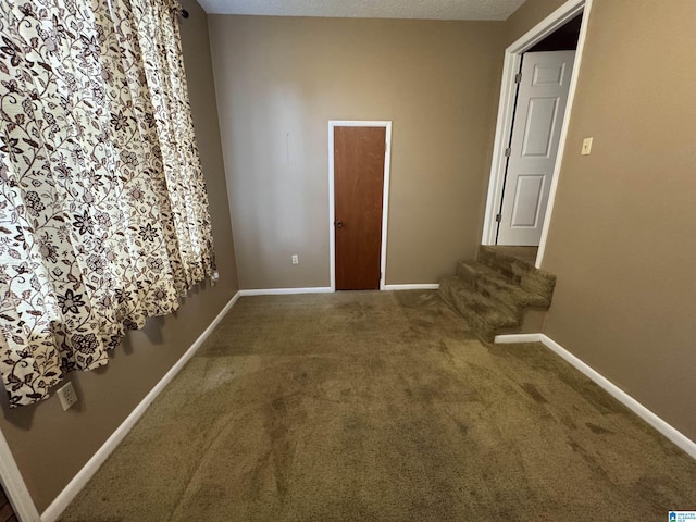 spare room with carpet flooring and baseboards