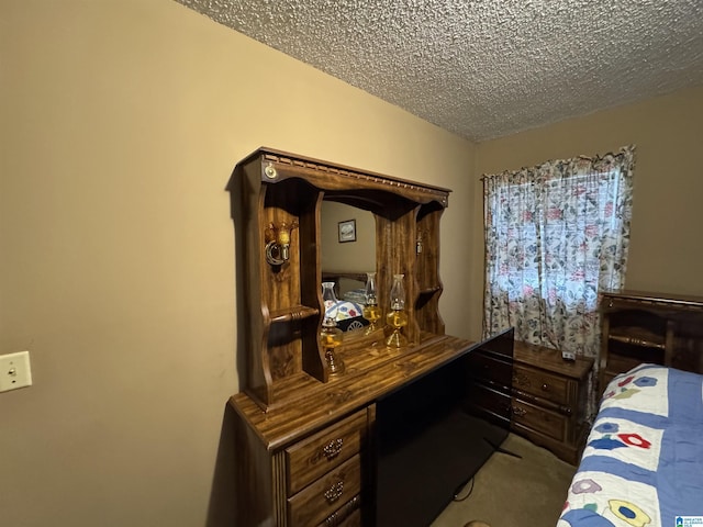 bedroom with a textured ceiling and carpet