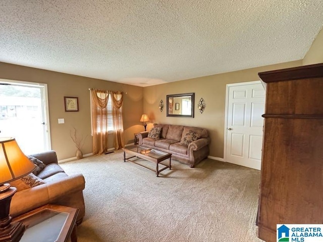 living room with a textured ceiling, carpet flooring, and baseboards