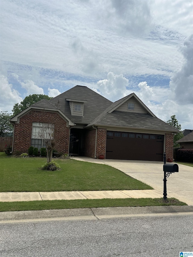 view of front of home featuring brick siding, an attached garage, a front yard, and concrete driveway