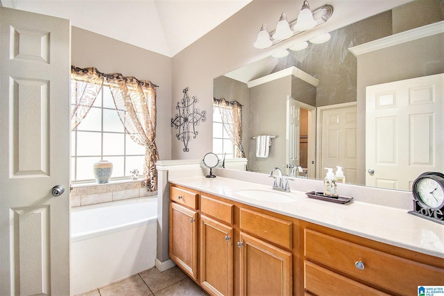 full bathroom featuring a garden tub, a healthy amount of sunlight, lofted ceiling, and vanity