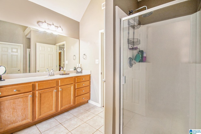full bathroom with vanity, vaulted ceiling, tile patterned flooring, and a stall shower