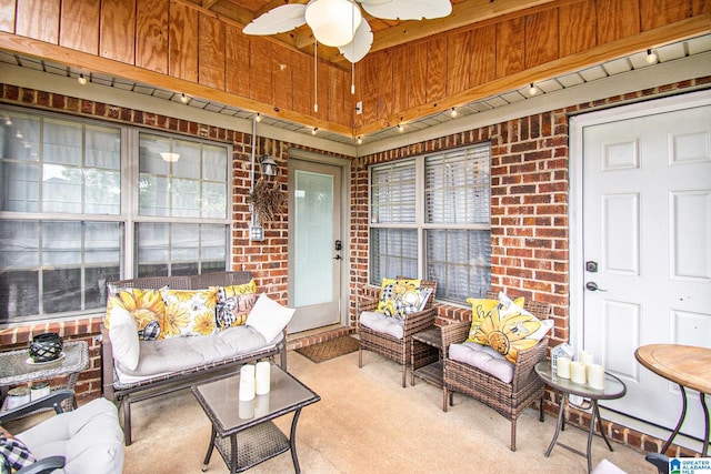 sunroom / solarium featuring a ceiling fan