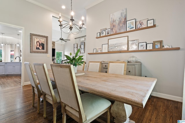 dining space featuring a chandelier, baseboards, dark wood finished floors, ornamental molding, and ceiling fan