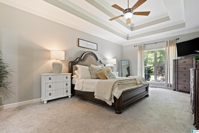 bedroom with light carpet, ornamental molding, a raised ceiling, ceiling fan, and baseboards