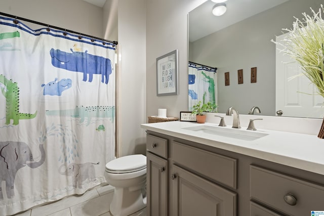bathroom with tile patterned floors, toilet, vanity, and curtained shower