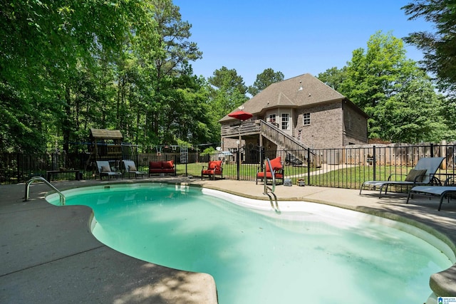 view of swimming pool with a patio area, fence, and stairway