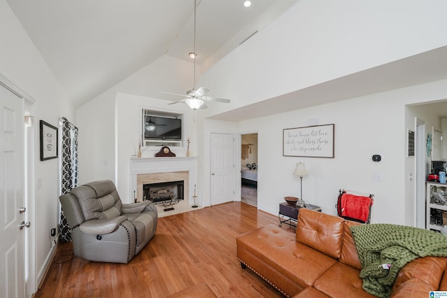 20443 Hepzibah Church Rd, Mccalla, AL 35111 - living room with a ceiling fan, a fireplace with flush hearth, baseboards, lofted ceiling, and light wood-style flooring