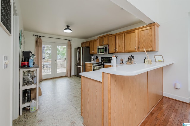 20443 Hepzibah Church Rd, Mccalla, AL 35111 - kitchen with brown cabinetry, a peninsula, light countertops, french doors, and stainless steel appliances