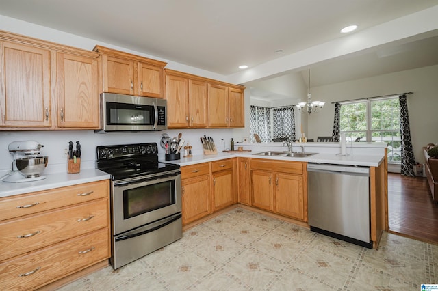 20443 Hepzibah Church Rd, Mccalla, AL 35111 - kitchen with an inviting chandelier, a sink, light countertops, stainless steel appliances, and a peninsula