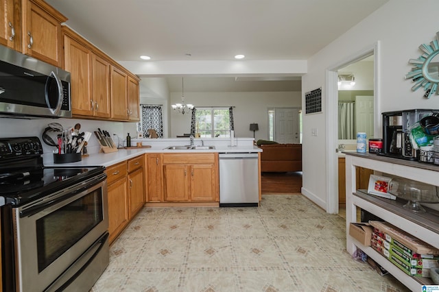 20443 Hepzibah Church Rd, Mccalla, AL 35111 - kitchen featuring a peninsula, light countertops, a chandelier, a sink, and stainless steel appliances