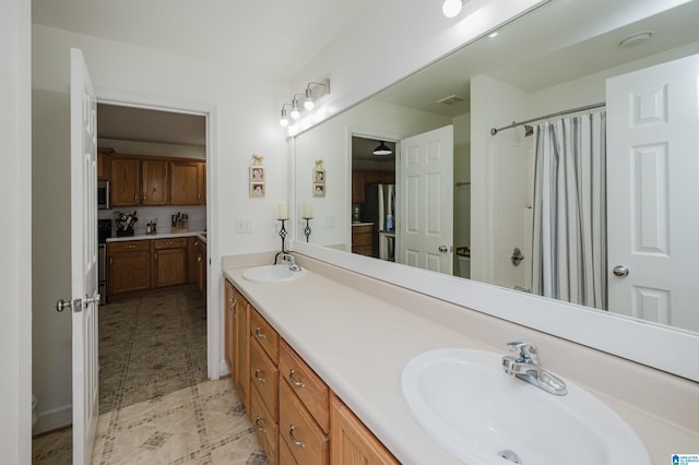 20443 Hepzibah Church Rd, Mccalla, AL 35111 - full bath featuring a sink, tile patterned flooring, double vanity, and a shower with shower curtain