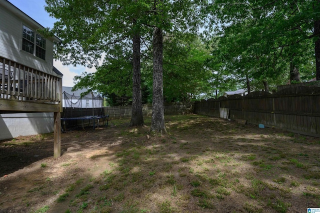 20443 Hepzibah Church Rd, Mccalla, AL 35111 - view of yard with a wooden deck, a fenced backyard, and a trampoline