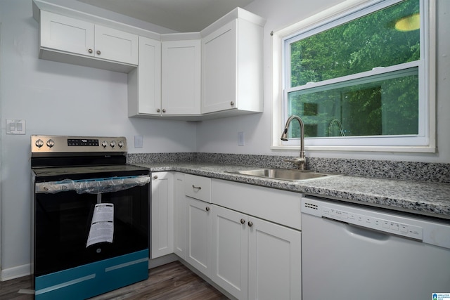 kitchen featuring a sink, dishwasher, stainless steel electric range oven, and dark wood finished floors