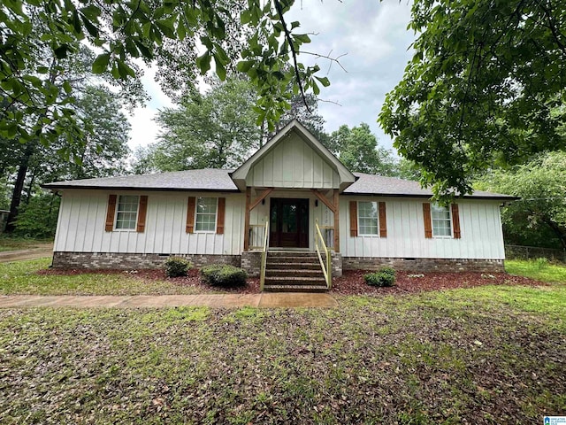 single story home featuring board and batten siding, a shingled roof, and crawl space