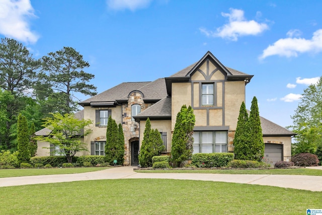 view of front of house with a front lawn, stone siding, stucco siding, and a shingled roof