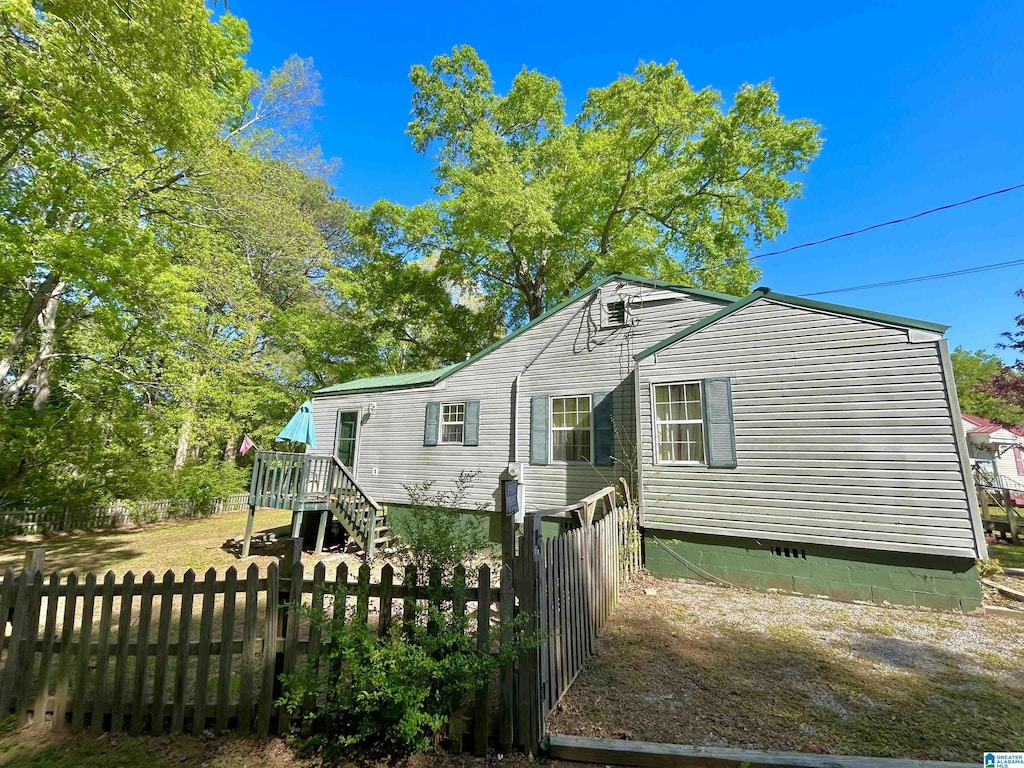 view of side of property featuring a deck and fence private yard