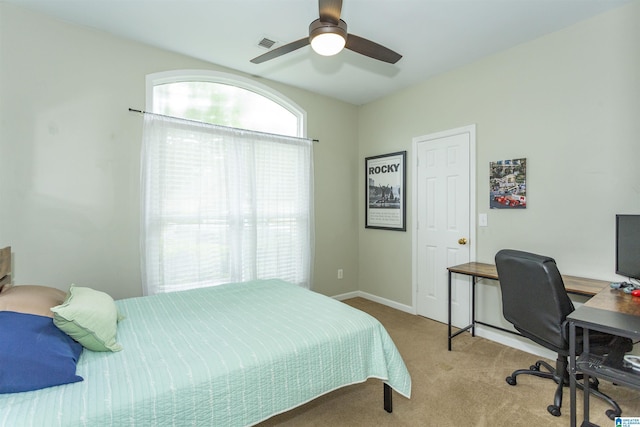 bedroom with baseboards, visible vents, ceiling fan, and carpet