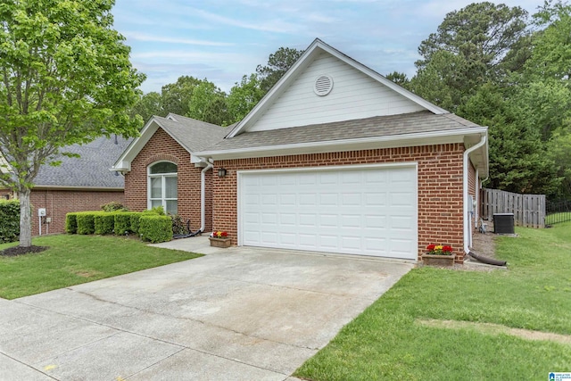view of front of property with roof with shingles, concrete driveway, a front yard, and brick siding