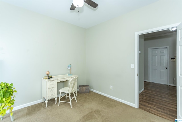 carpeted office featuring baseboards and ceiling fan