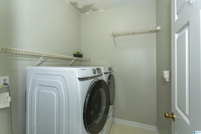 clothes washing area featuring baseboards, laundry area, and independent washer and dryer