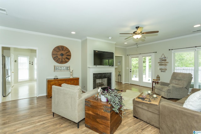 living area featuring ceiling fan, visible vents, and light wood-type flooring