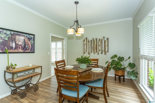 dining area with crown molding, baseboards, wood finished floors, and a healthy amount of sunlight