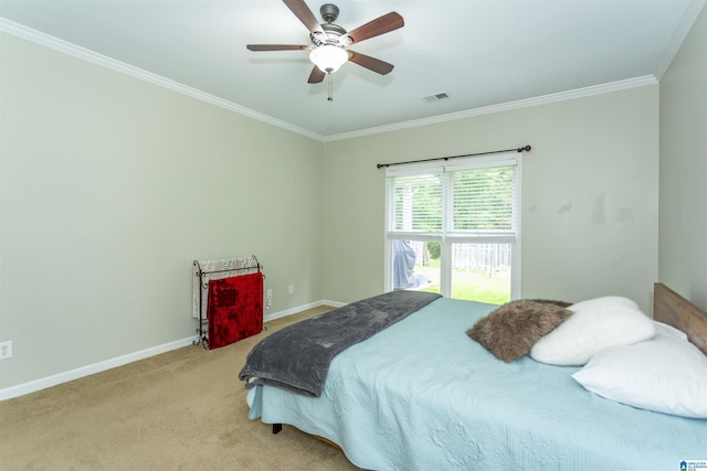 bedroom featuring crown molding, baseboards, visible vents, and carpet