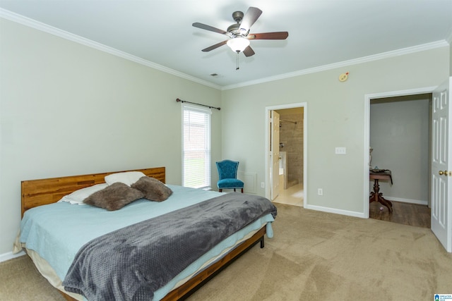 carpeted bedroom with baseboards, ornamental molding, connected bathroom, and a ceiling fan
