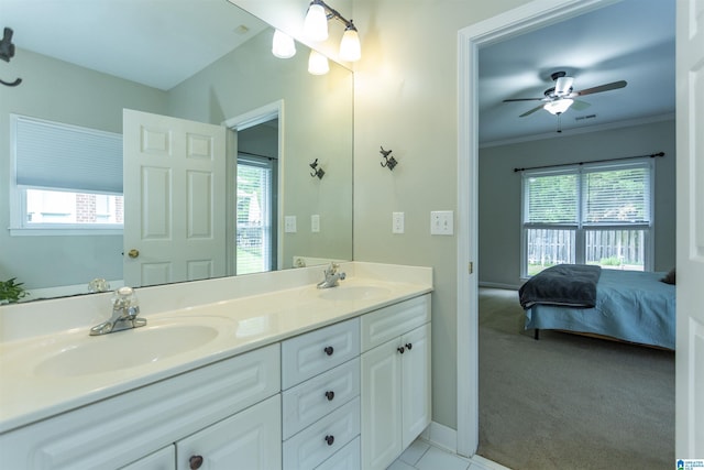 ensuite bathroom with a ceiling fan, plenty of natural light, and a sink