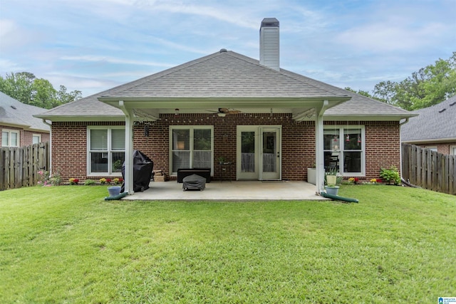rear view of property featuring a fenced backyard, a ceiling fan, a patio, and a lawn