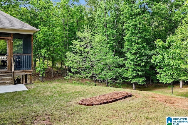 view of yard with stairs and a sunroom