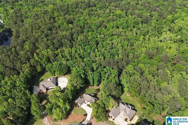 birds eye view of property featuring a view of trees