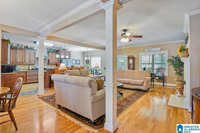 living room with a ceiling fan, decorative columns, plenty of natural light, and light wood-style floors