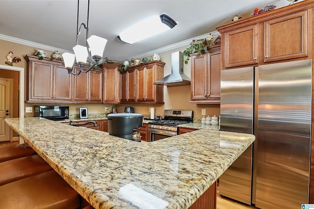 kitchen featuring light stone counters, ornamental molding, wall chimney exhaust hood, and appliances with stainless steel finishes