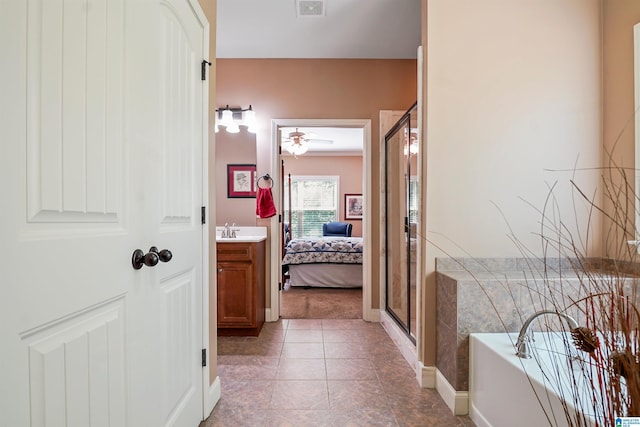 full bath featuring connected bathroom, vanity, a shower stall, visible vents, and a bath