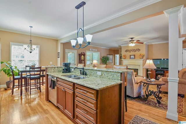 kitchen featuring light wood-style floors, a sink, ceiling fan with notable chandelier, and dishwasher
