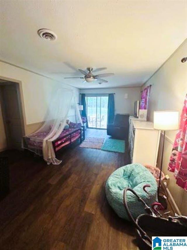 bedroom featuring visible vents, a ceiling fan, and dark wood finished floors