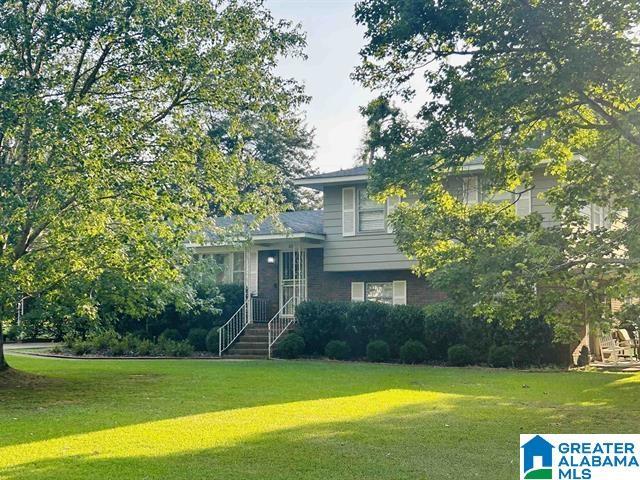 tri-level home with a front lawn