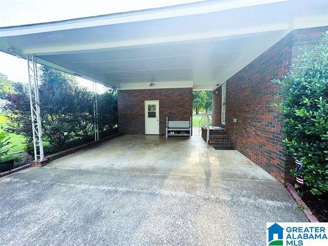 view of vehicle parking featuring a carport and driveway