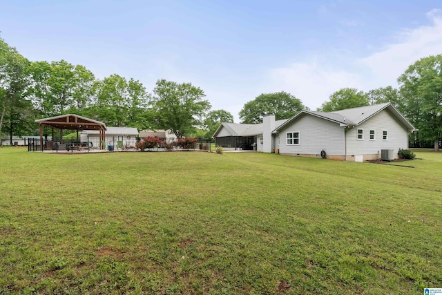 view of yard with fence, a gazebo, and cooling unit
