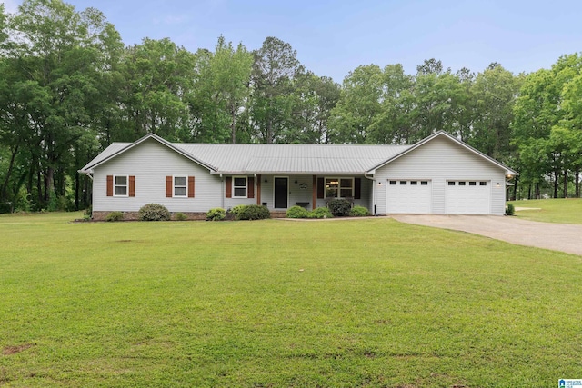 single story home with metal roof, a front yard, concrete driveway, and an attached garage