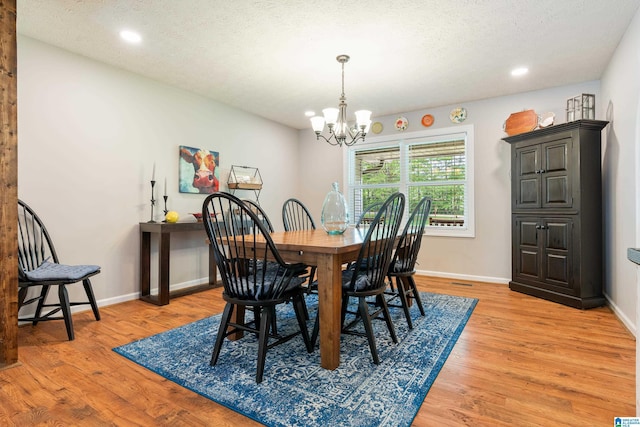 dining area featuring a chandelier, light wood-type flooring, recessed lighting, and baseboards